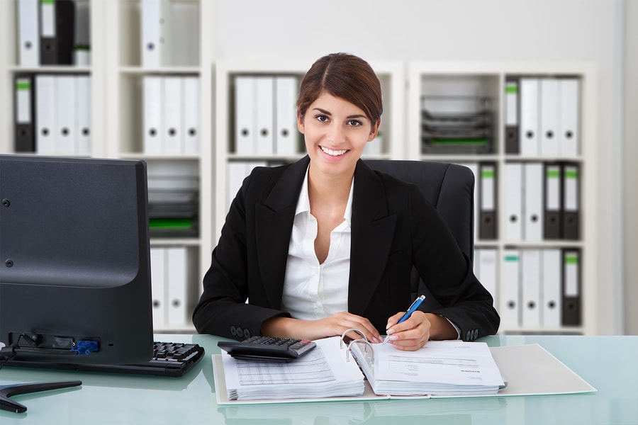 Female Accountant Writing On Desk