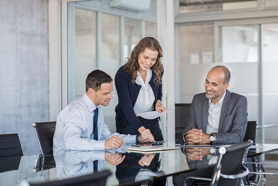 Smiling business team working together on a project in a modern